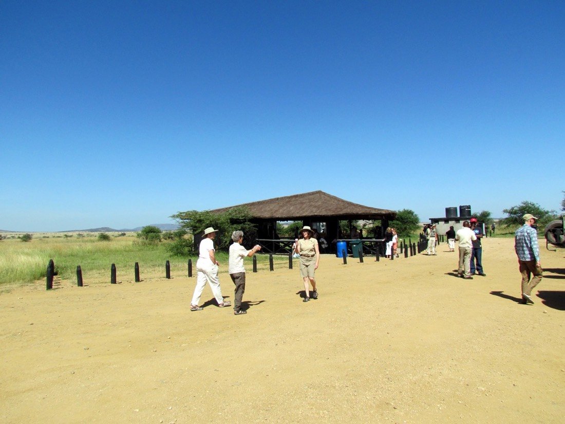 Photographer with camera on safari vehicle