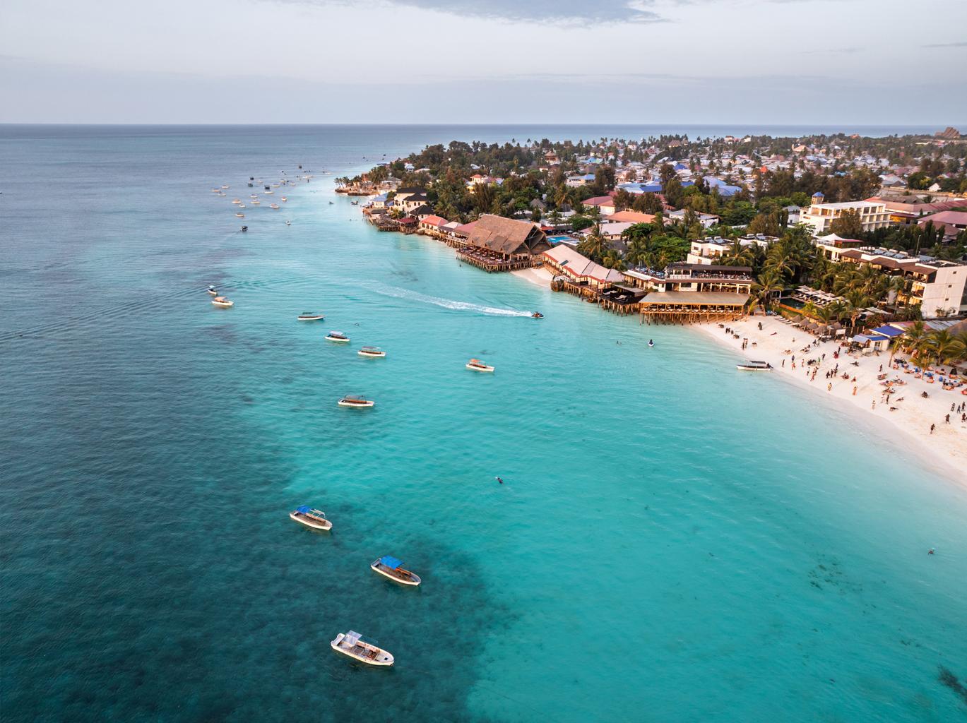 Bright Zanzibar beach and turquoise ocean shoreline